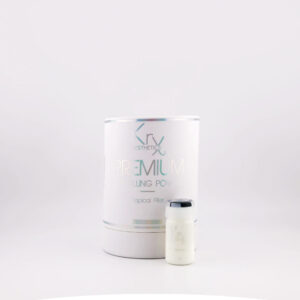 Das Bild zeigt ein hochwertiges Kosmetikprodukt von KrX Aesthetics mit dem Namen PREMIUM HA FILLING POWDER. Die Produktverpackung ist zylindrisch, in einem matten Weißton gehalten, mit metallisch schimmernden Schriftzügen in Grün und Grau. Im oberen Bereich befindet sich das Markenlogo „KrX AESTHETICS“. Darunter steht in großen Buchstaben der Produktname „PREMIUM HA FILLING POWDER“ sowie in kleinerer Schrift „Topical Filler“, was darauf hinweist, dass es sich um einen oberflächlich wirkenden Filler handelt – vermutlich auf Basis von Hyaluronsäure (HA = Hyaluronic Acid). Rechts neben der Verpackung ist ein kleines, ebenfalls weißes Fläschchen mit silberfarbenem Deckel zu sehen – vermutlich eine der enthaltenen Einzeldosen.