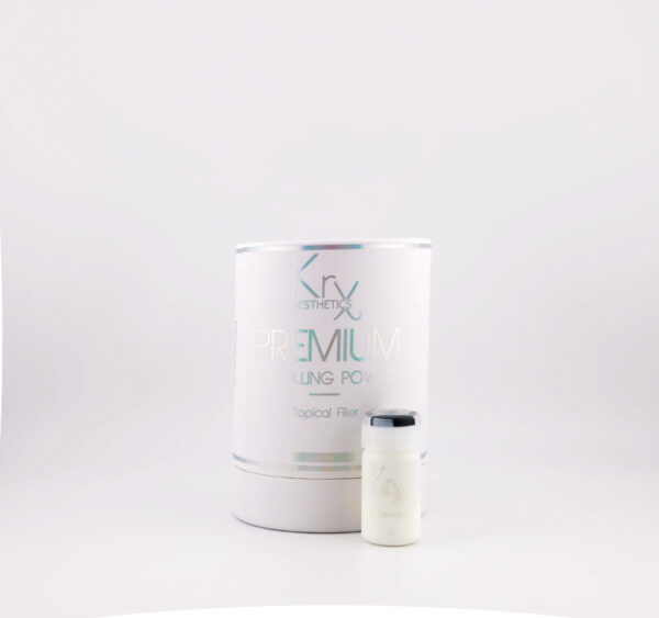 Das Bild zeigt ein hochwertiges Kosmetikprodukt von KrX Aesthetics mit dem Namen PREMIUM HA FILLING POWDER. Die Produktverpackung ist zylindrisch, in einem matten Weißton gehalten, mit metallisch schimmernden Schriftzügen in Grün und Grau. Im oberen Bereich befindet sich das Markenlogo „KrX AESTHETICS“. Darunter steht in großen Buchstaben der Produktname „PREMIUM HA FILLING POWDER“ sowie in kleinerer Schrift „Topical Filler“, was darauf hinweist, dass es sich um einen oberflächlich wirkenden Filler handelt – vermutlich auf Basis von Hyaluronsäure (HA = Hyaluronic Acid). Rechts neben der Verpackung ist ein kleines, ebenfalls weißes Fläschchen mit silberfarbenem Deckel zu sehen – vermutlich eine der enthaltenen Einzeldosen.
